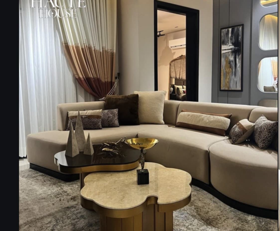 Isla sectional sofa in cream boucle with brass-based coffee table